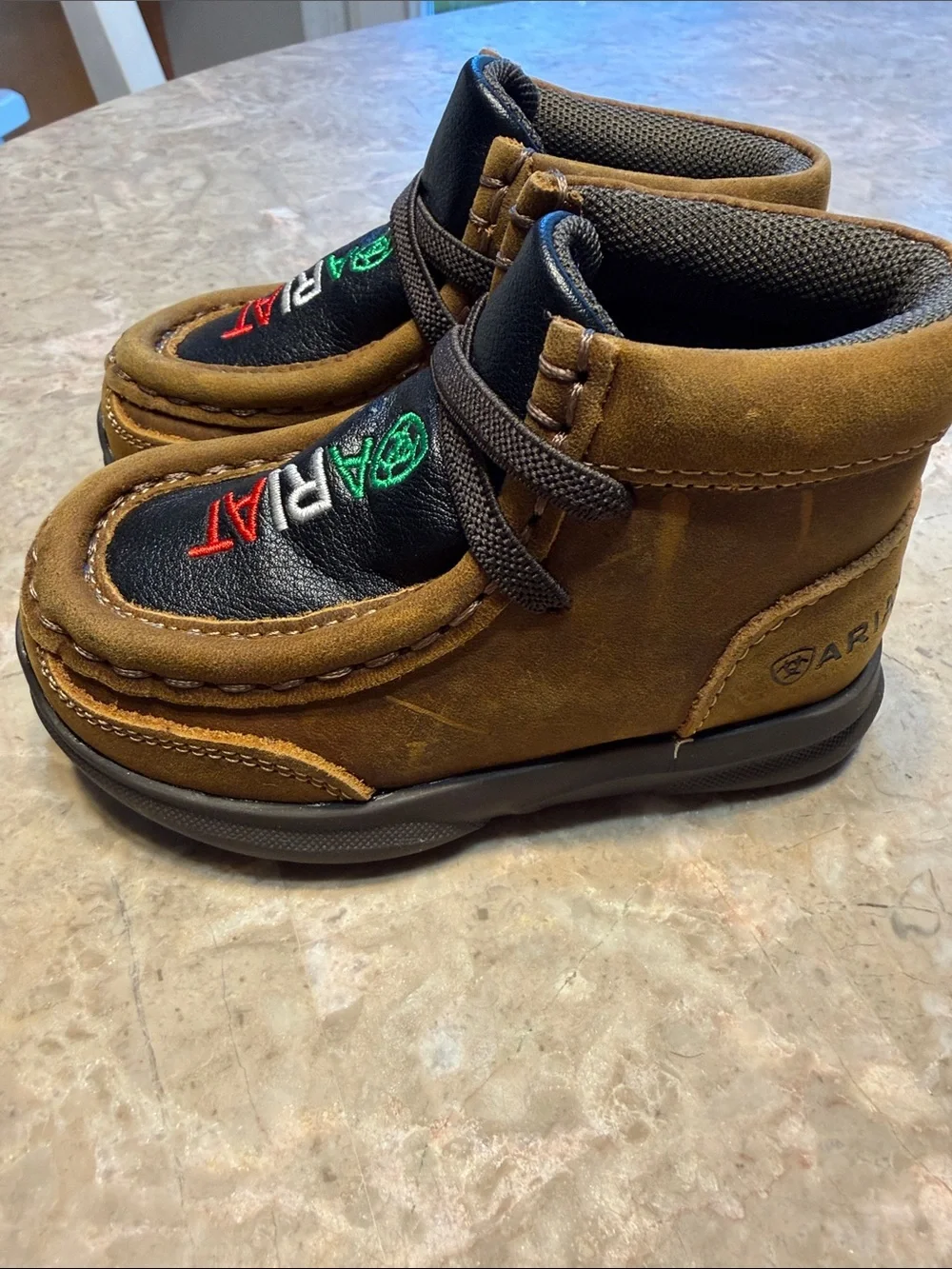 Ariat Kids Suede Moccasins in Brown with Black Inlay